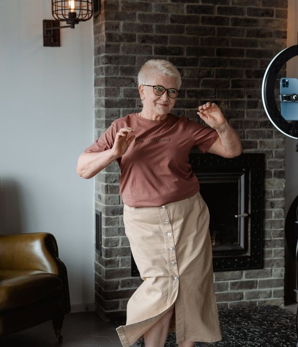 Woman feeling energetic and full of life in a bright space.